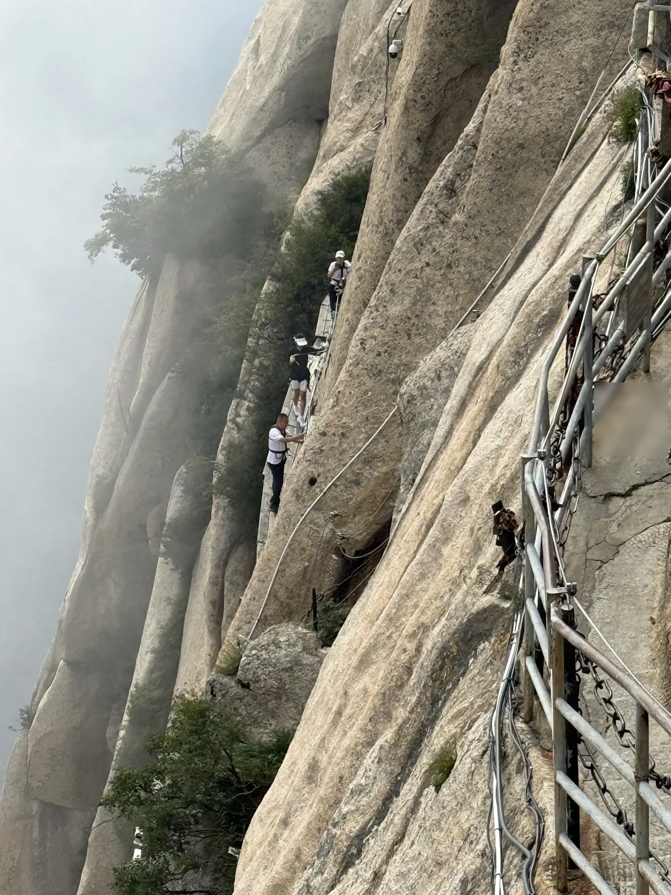 Travelers on Huashan's Changkong Zhandao plank walk