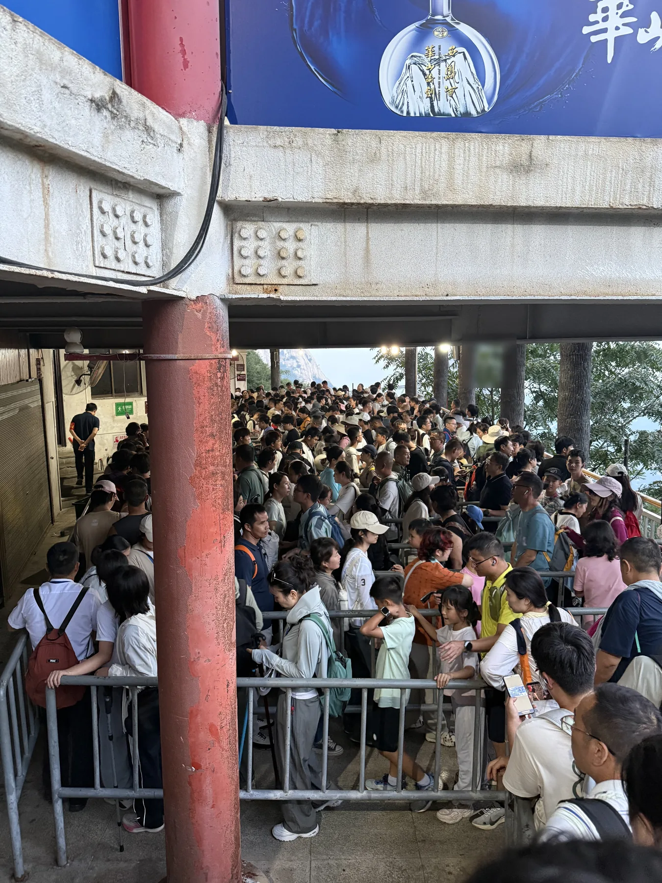 Large crowd waiting near the North Peak cable-car boarding area